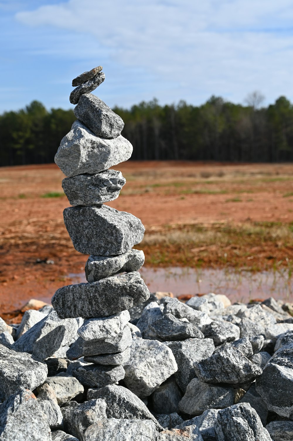 a pile of rocks sitting in the middle of a field