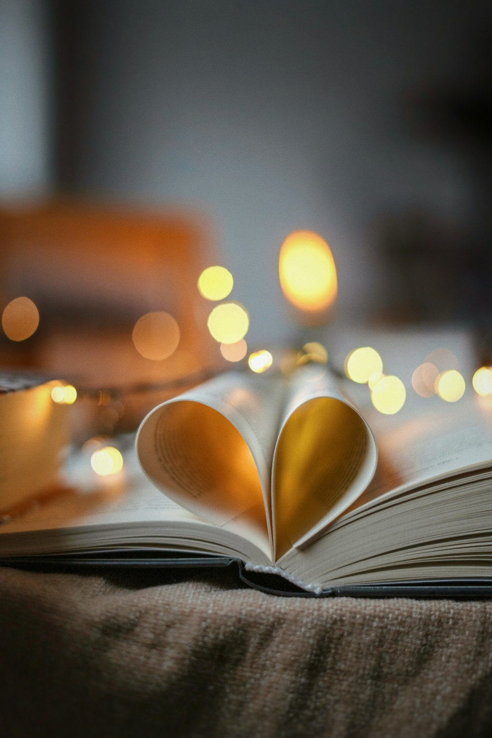 an open book with a heart shaped pages