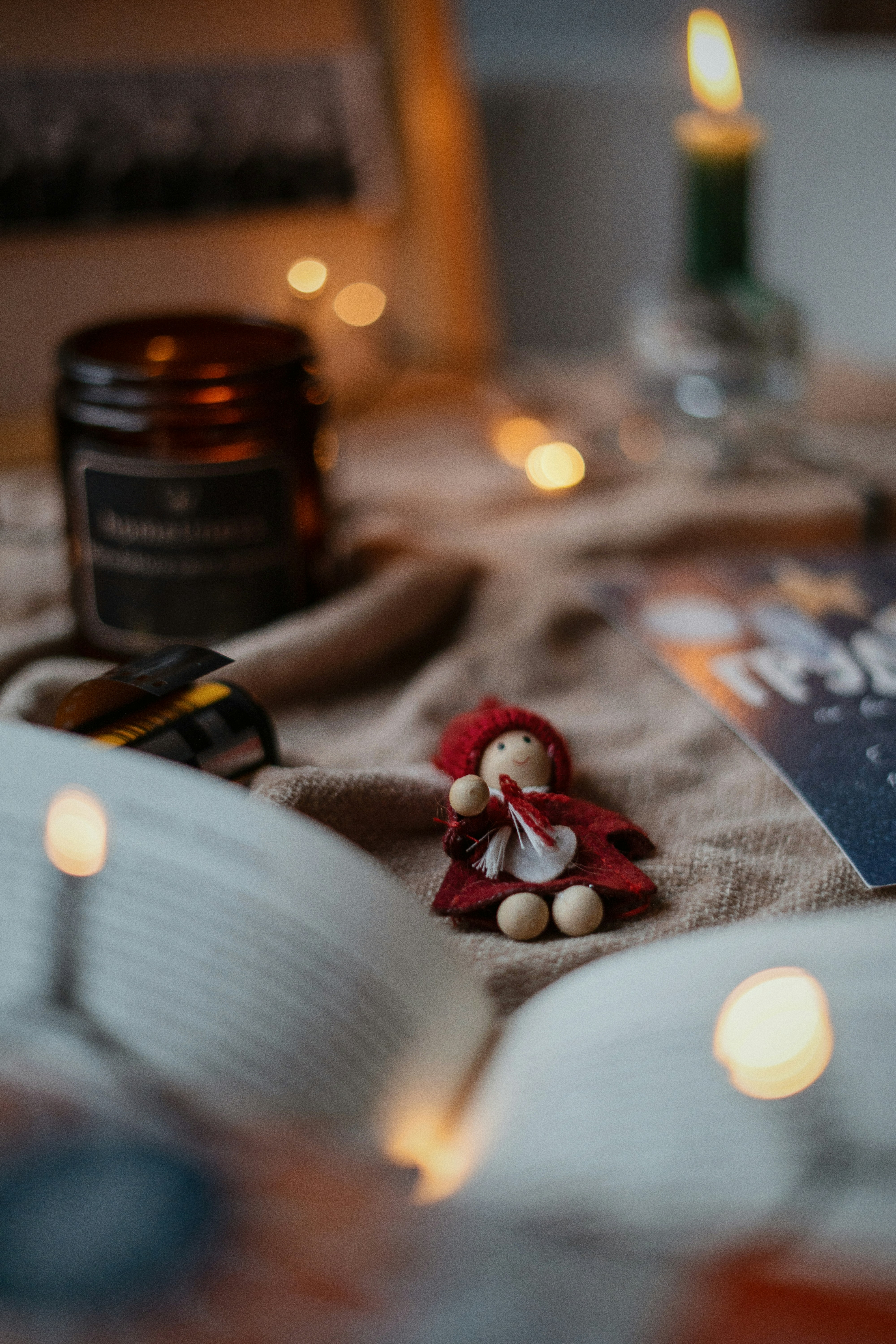 a stuffed animal sitting on top of a bed next to an open book