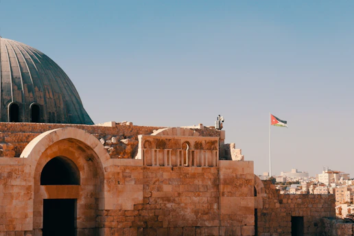 an old building with a flag on top of it
