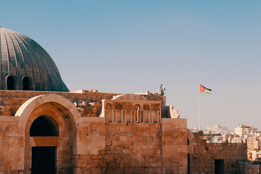 an old building with a flag on top of it