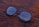 A close-up of stylish eyeglasses on a wooden table.