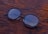 A close-up of stylish eyeglasses on a wooden table.