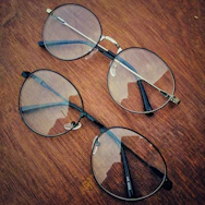 Close-up of elegant eyeglass frames displayed on a sleek wooden surface