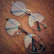 Close-up of sleek twinsight eyeglasses resting on a rustic wooden table.