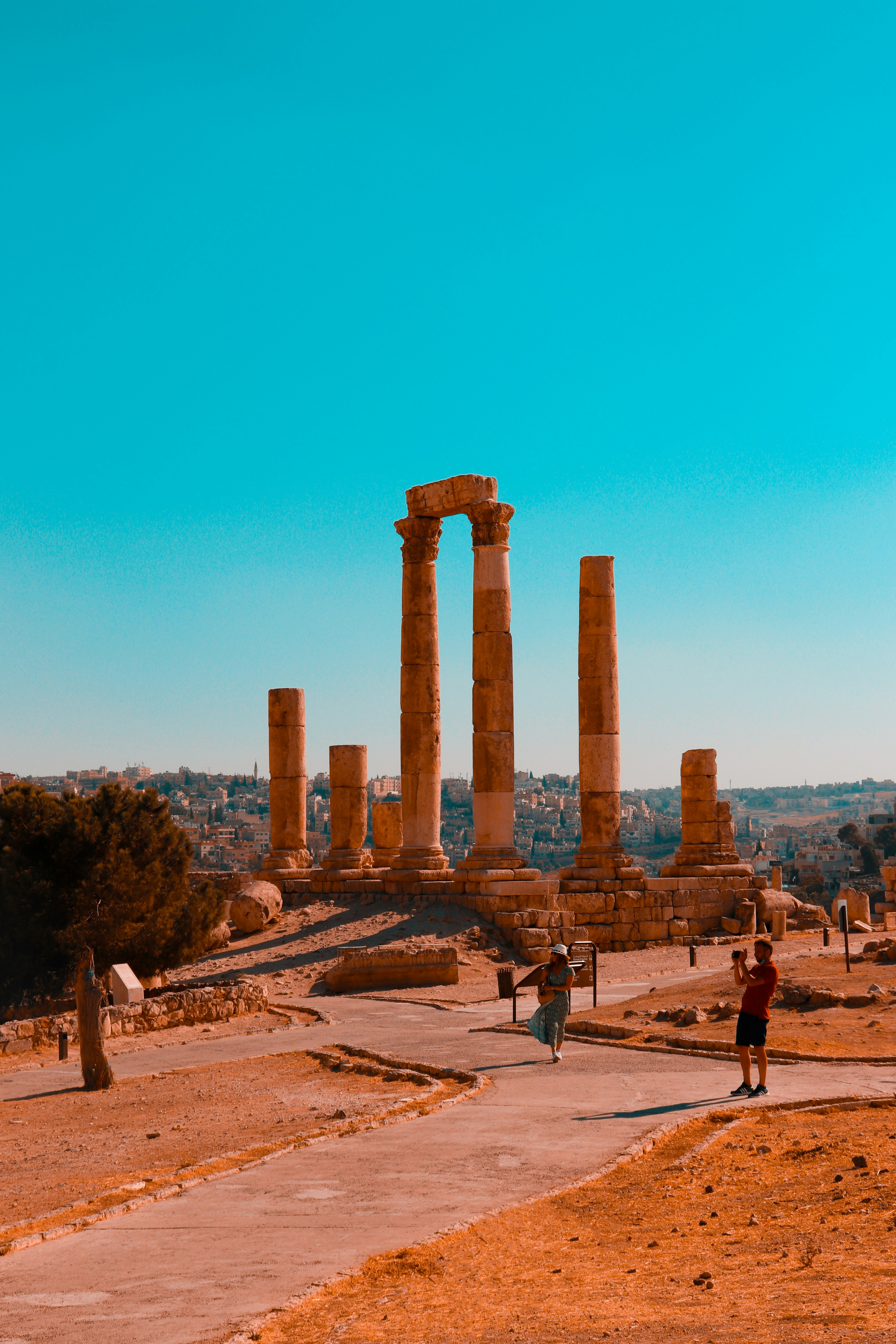 a group of people standing in front of some ancient ruins