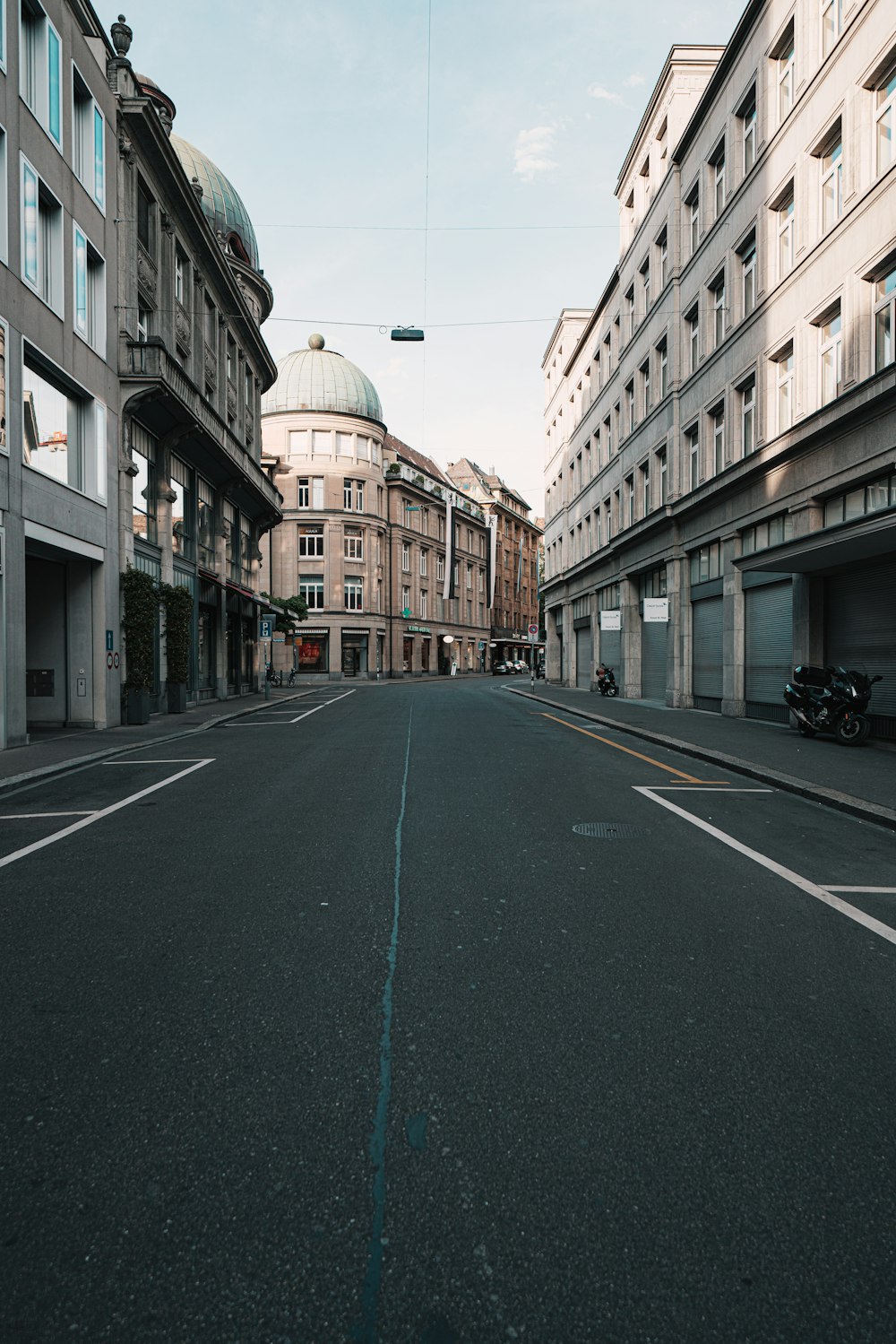 an empty city street with buildings on both sides