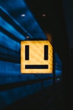 a yellow sign with a smiley face on it