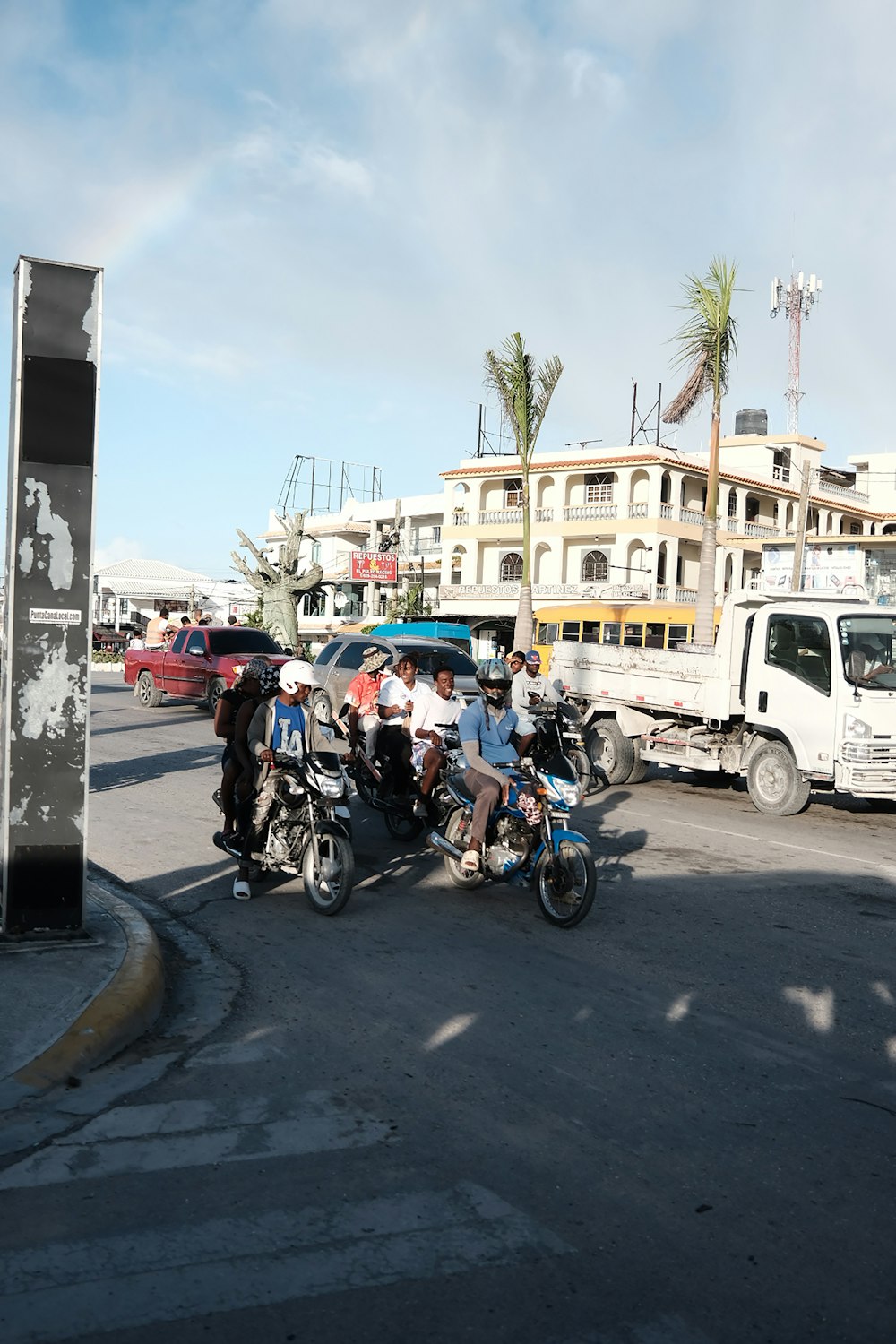 a group of people riding motorcycles down a street