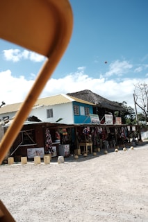 A vibrant market scene in Ziguinchor with colorful fabrics and local crafts displayed under bright sunlight.