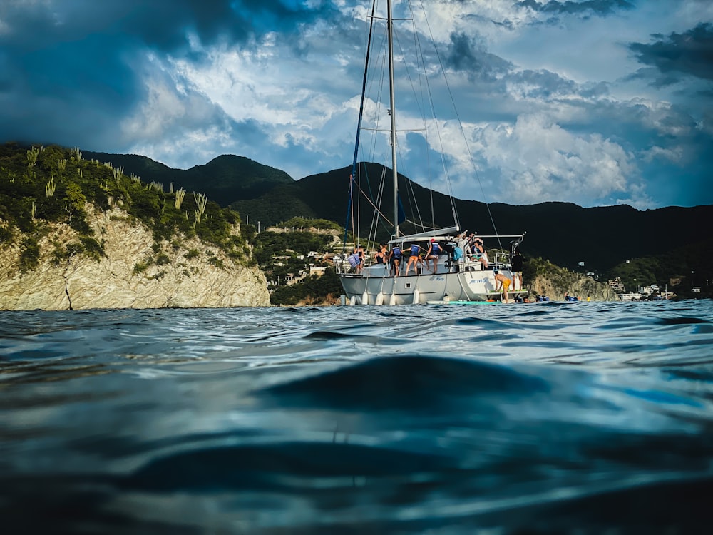 a group of people on a boat in the ocean