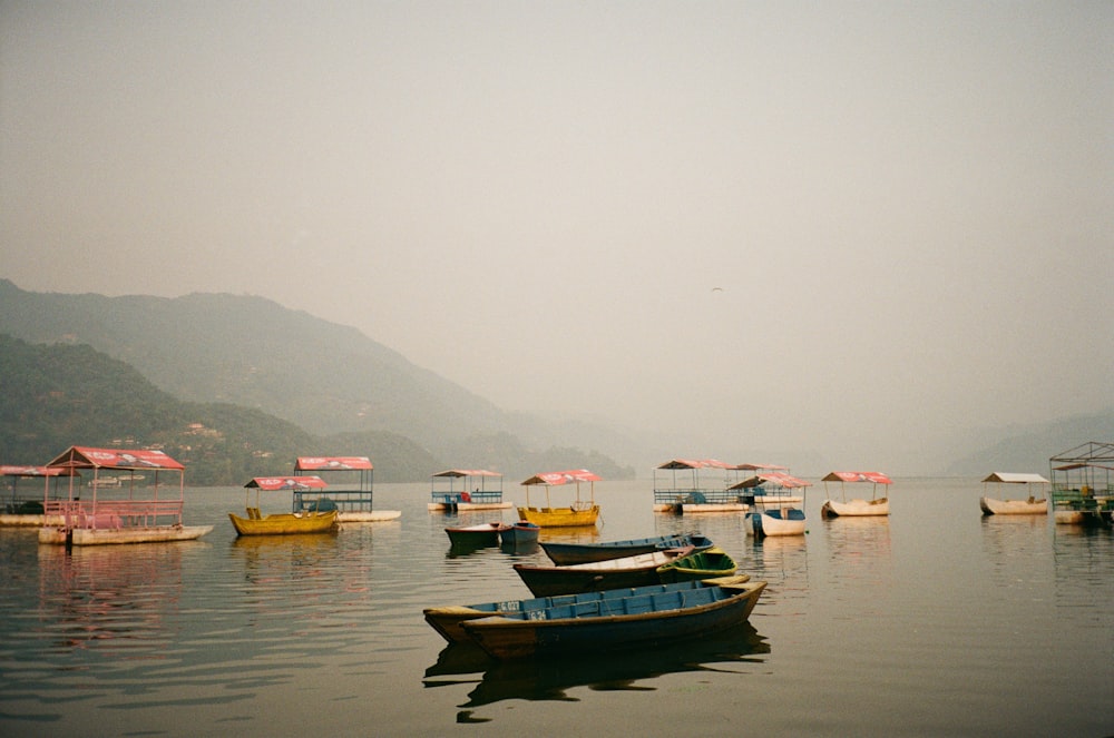 a group of boats floating on top of a lake