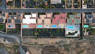 an aerial view of a street and houses