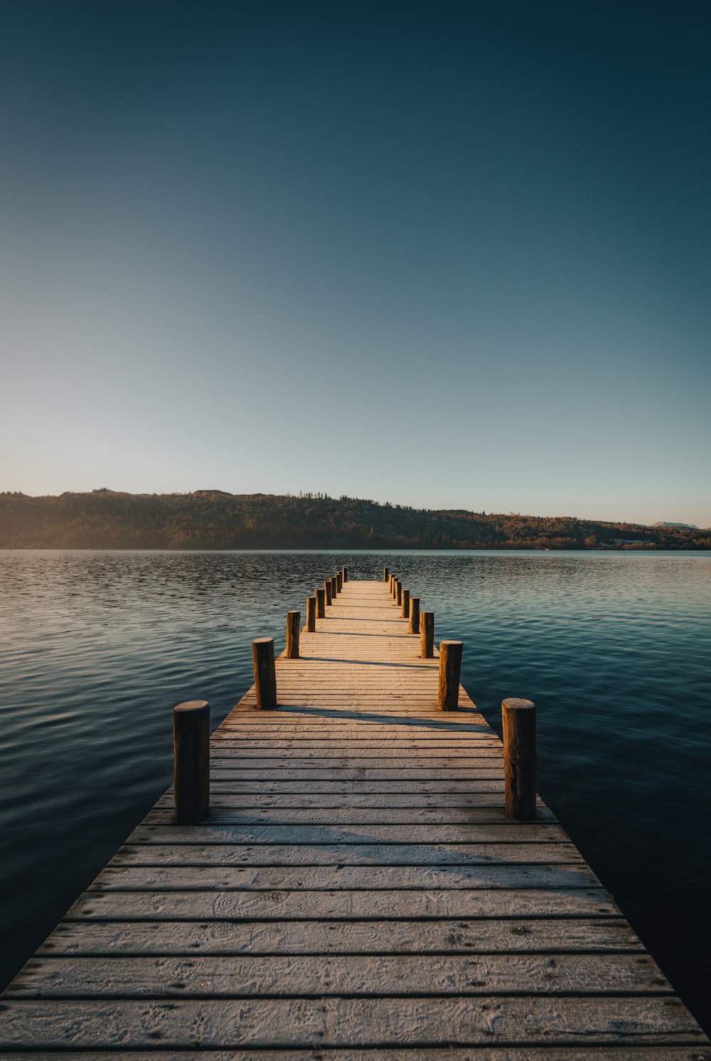 a wooden dock sitting on top of a body of water