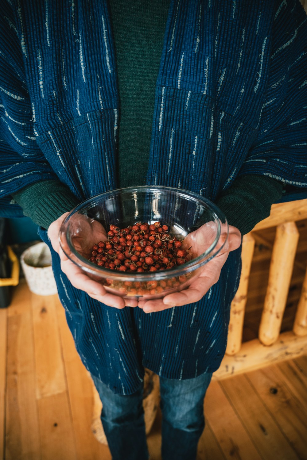 a person holding a bowl of food in their hands