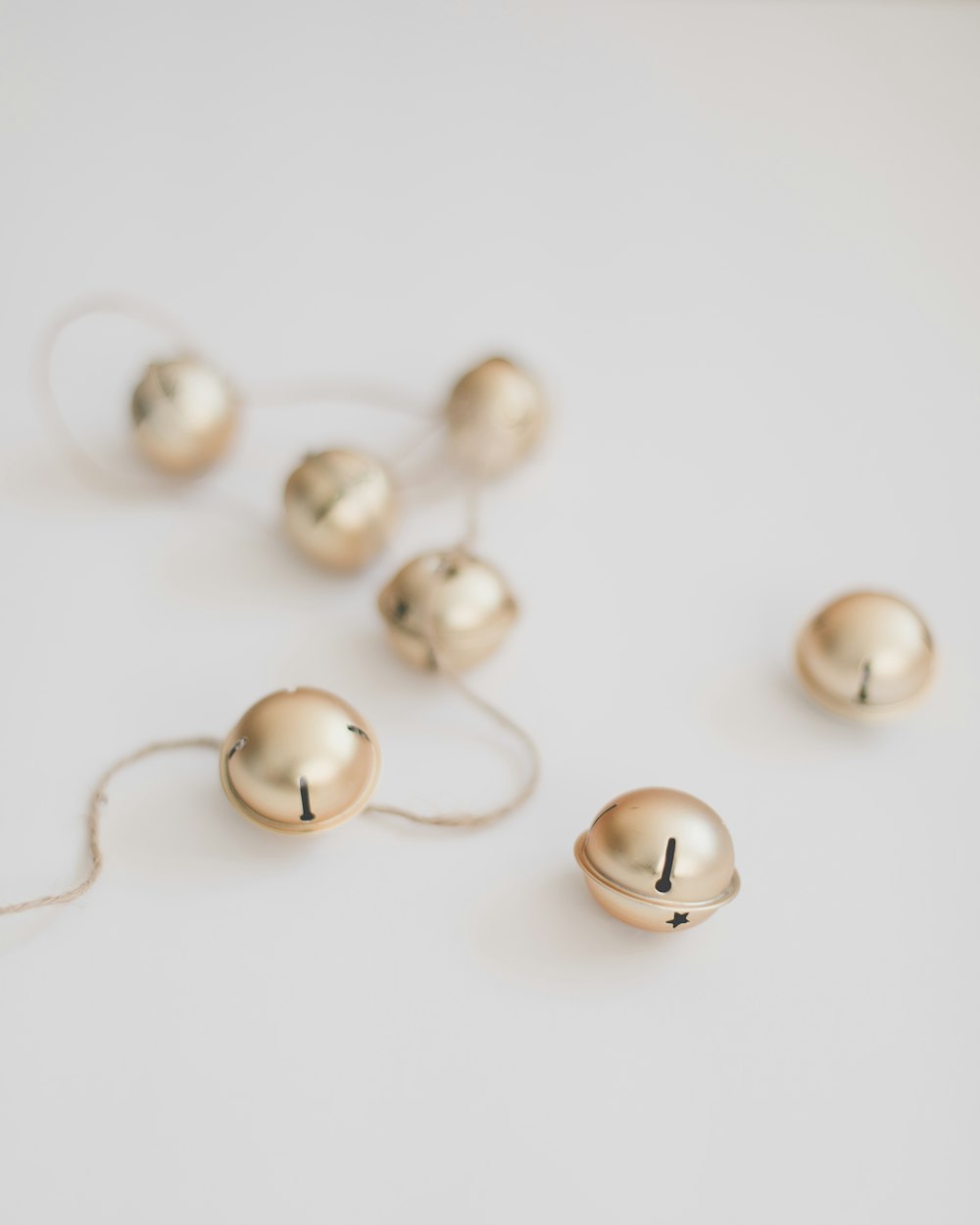 a white table topped with lots of gold balls