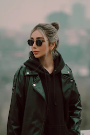 A stylish woman wearing an oversized streetwear hoodie against an urban backdrop.