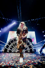 Sophisticated corporate event with saxophonist performing on stage.
