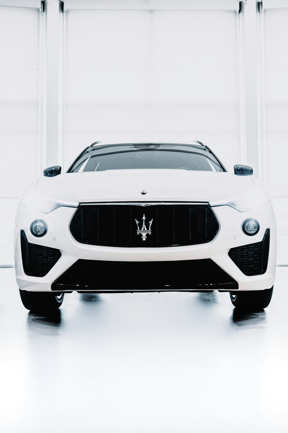 a white masera parked in a garage