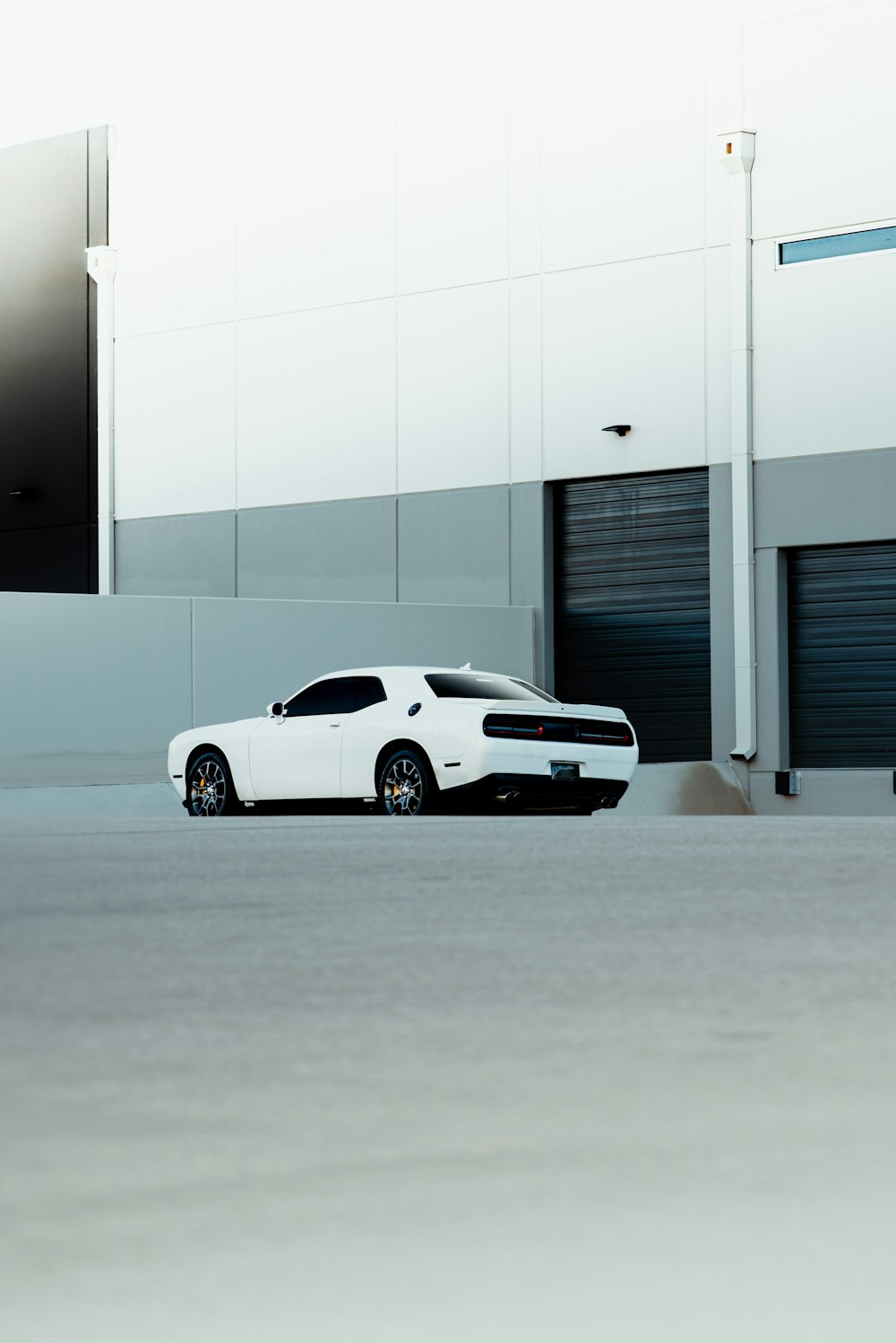 a white car parked in front of a building