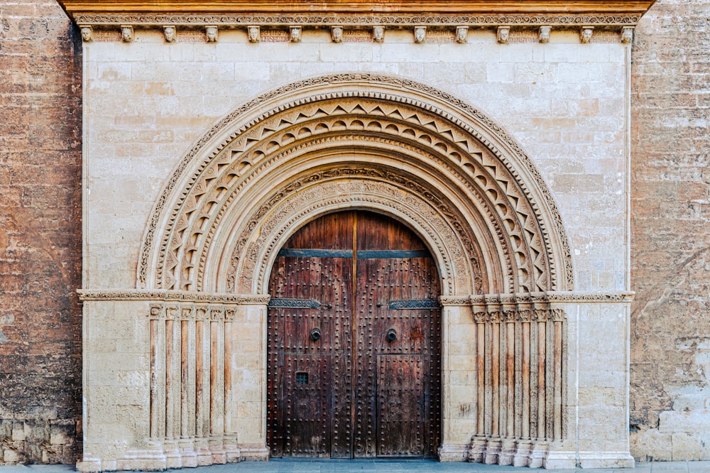 a large wooden door in front of a stone building