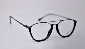 Elegant progressive lenses showcased with a modern black frame on a glass surface