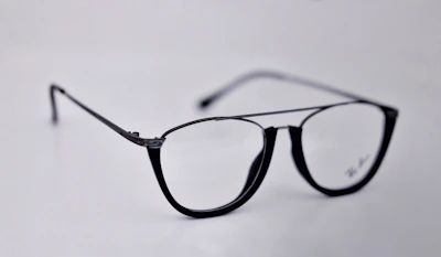 A sleek pair of eyeglasses with a modern frame on a wooden table.