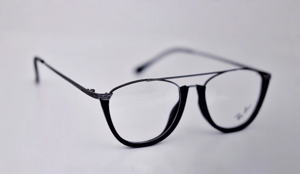 Close-up of elegant basic optical glasses with a sleek black frame on a vibrant red background