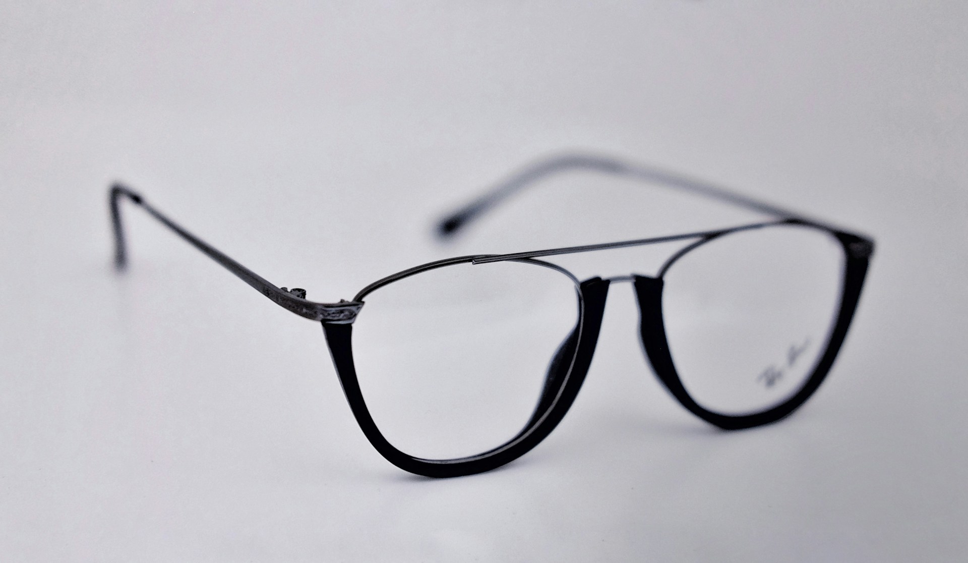 A stylish pair of eyeglasses displayed on a modern background.