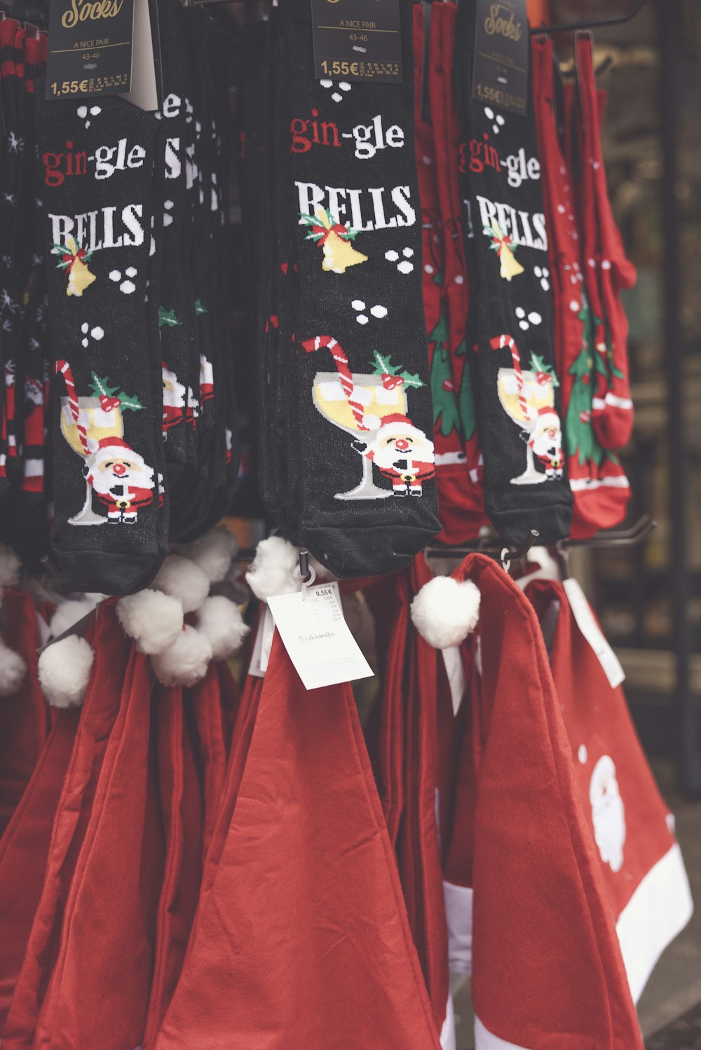 a bunch of christmas stockings hanging from a rack