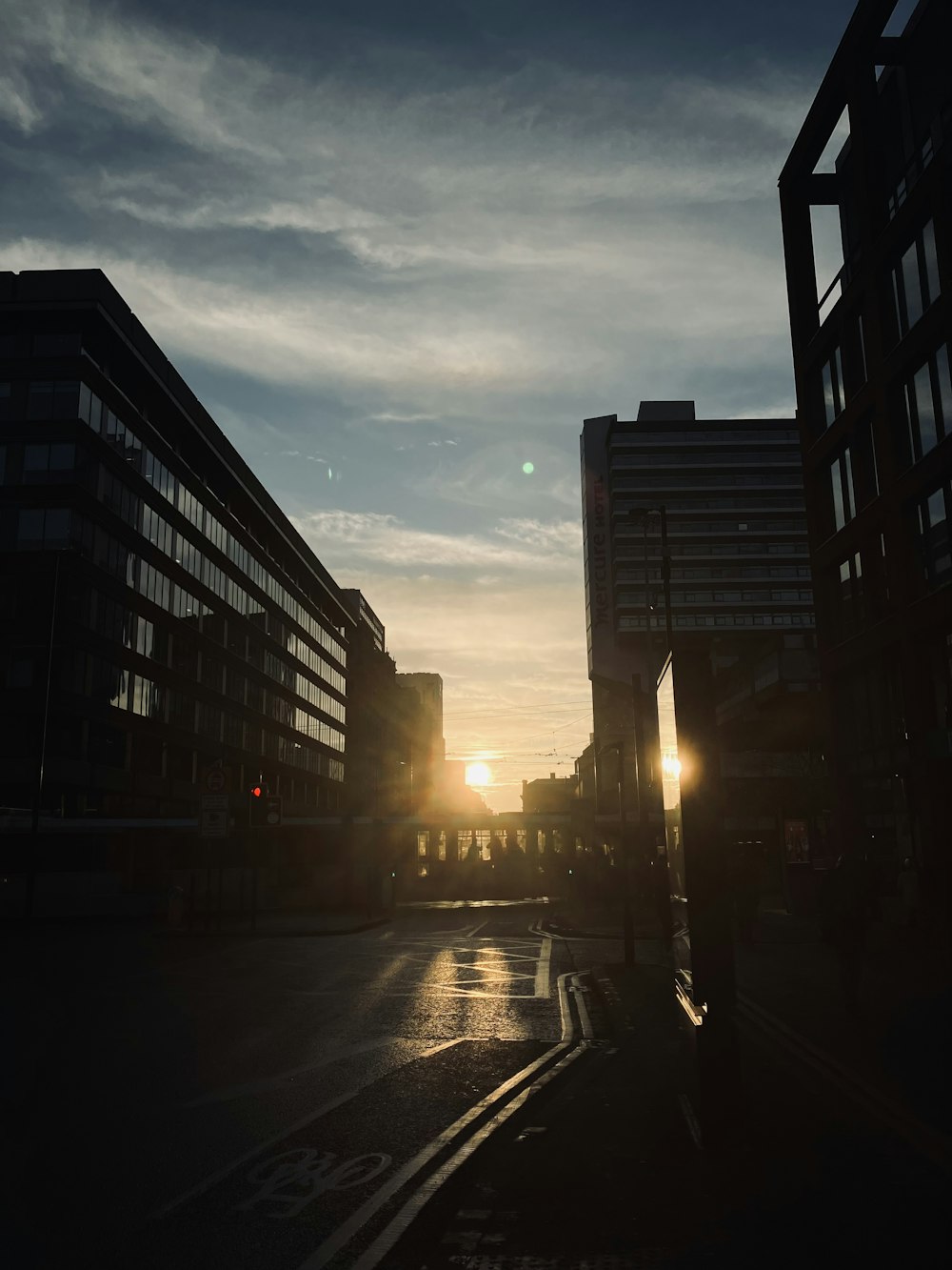 the sun is setting over a city street