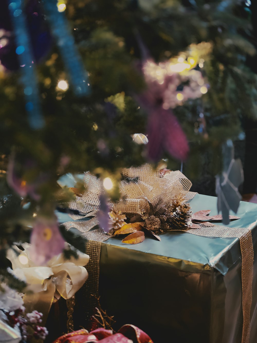 a wrapped present under a christmas tree