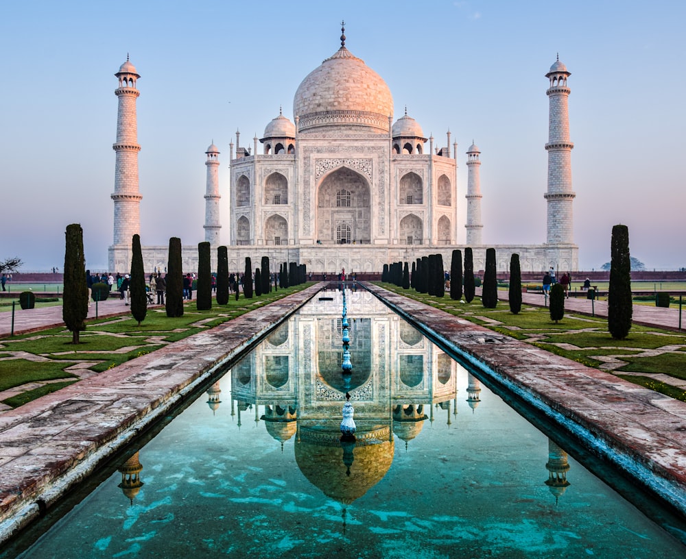 a reflection of a building in a pool of water