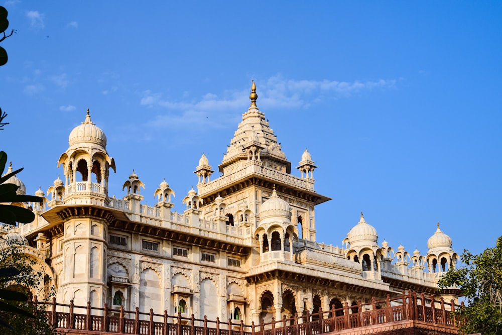 a large white building with two towers and a balcony