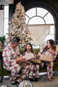 A happy family wearing matching jackets and pajamas, showcasing our range for all ages.
