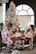A happy family wearing matching outfits, smiling together in a cozy living room.
