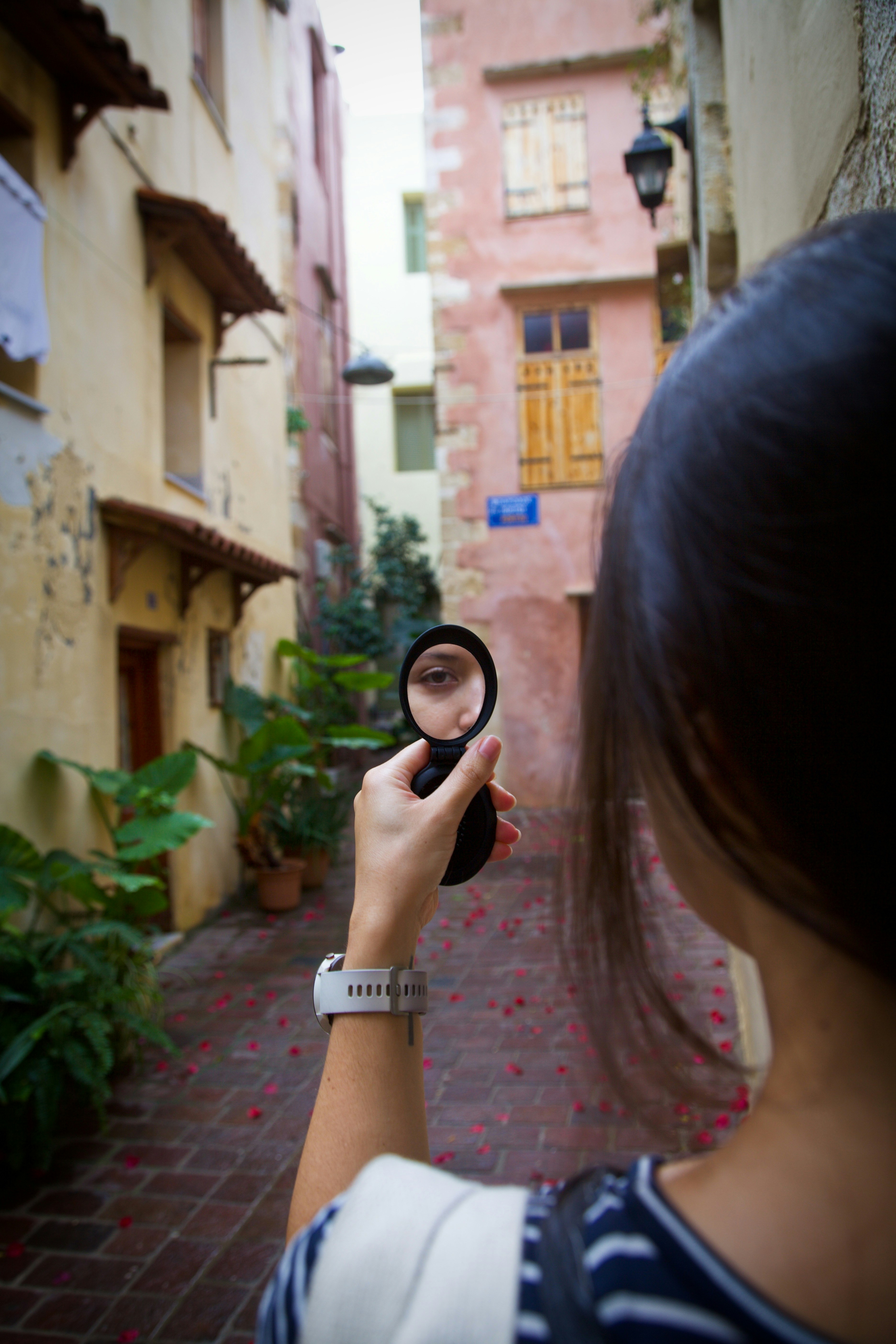 A woman holding a magnifying glass in her hand