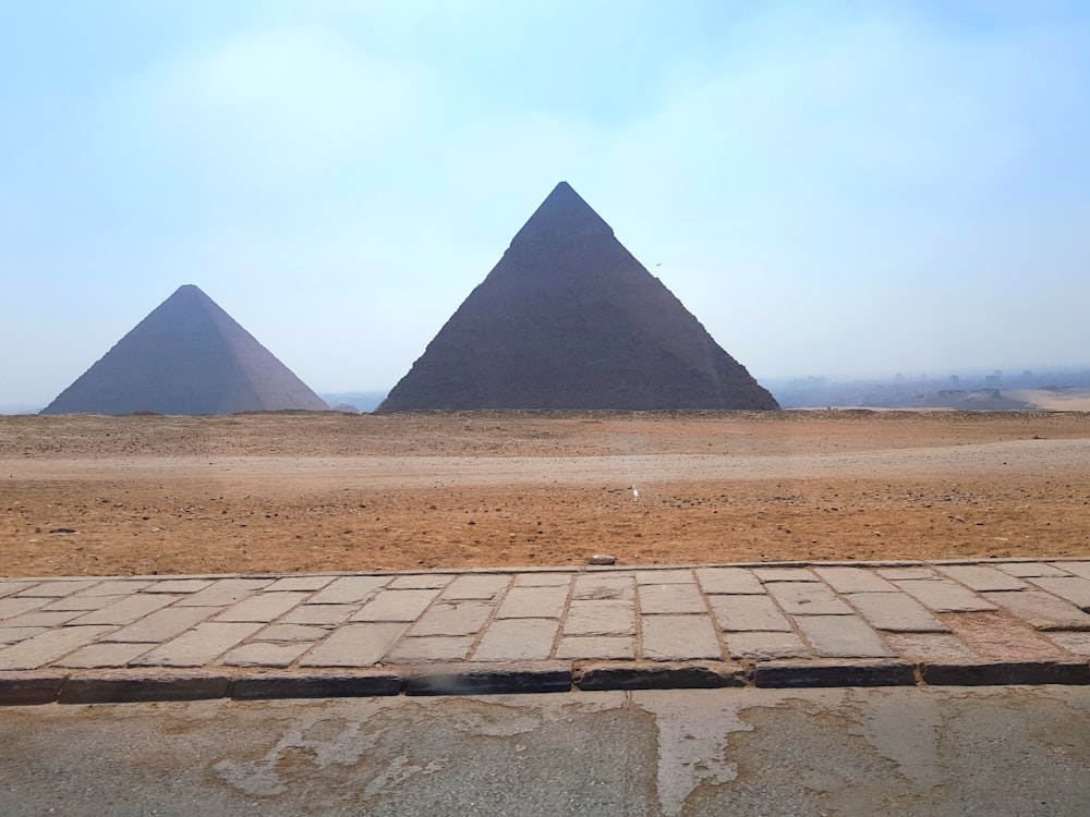 the three pyramids of giza are in the distance