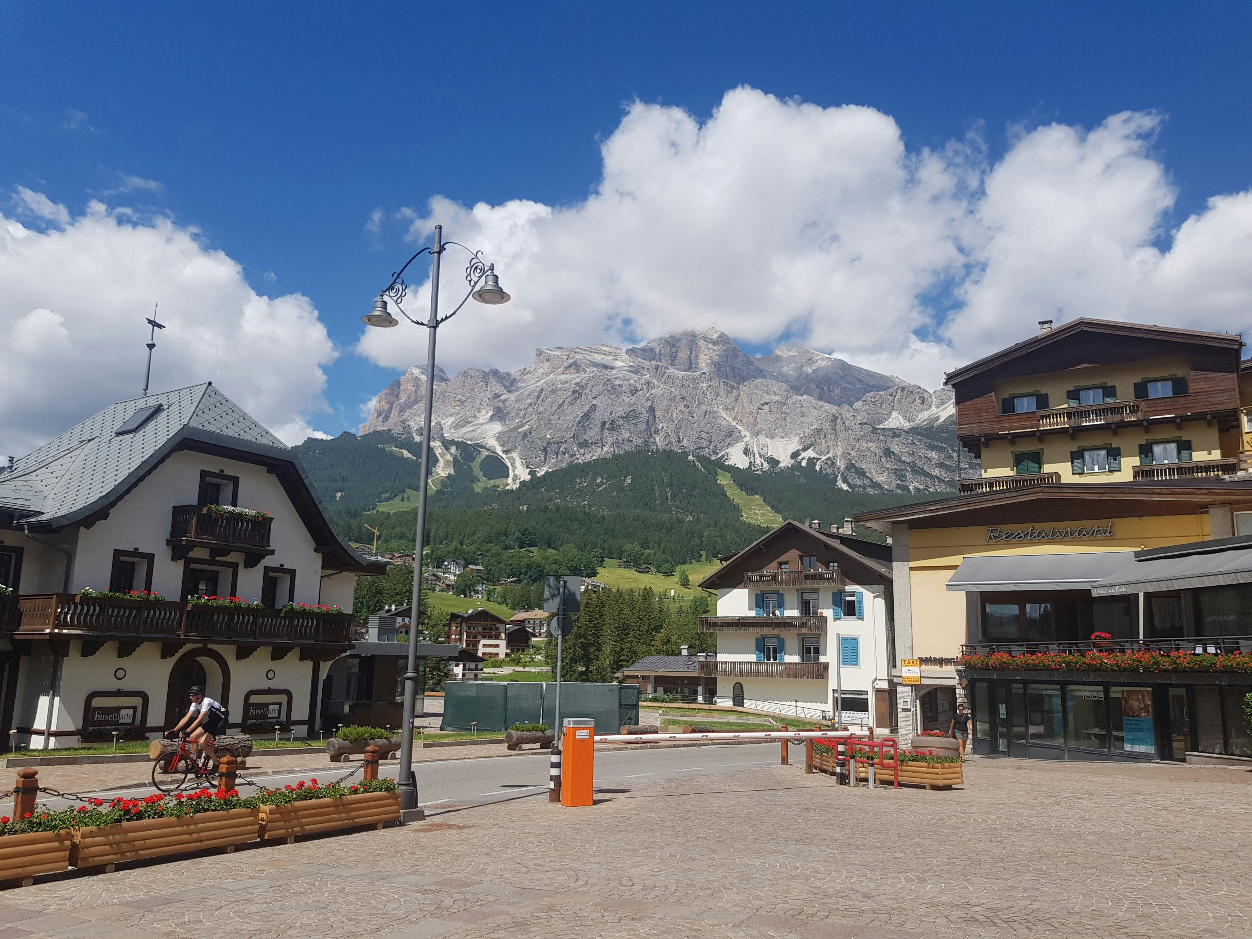 a town square with a mountain in the background