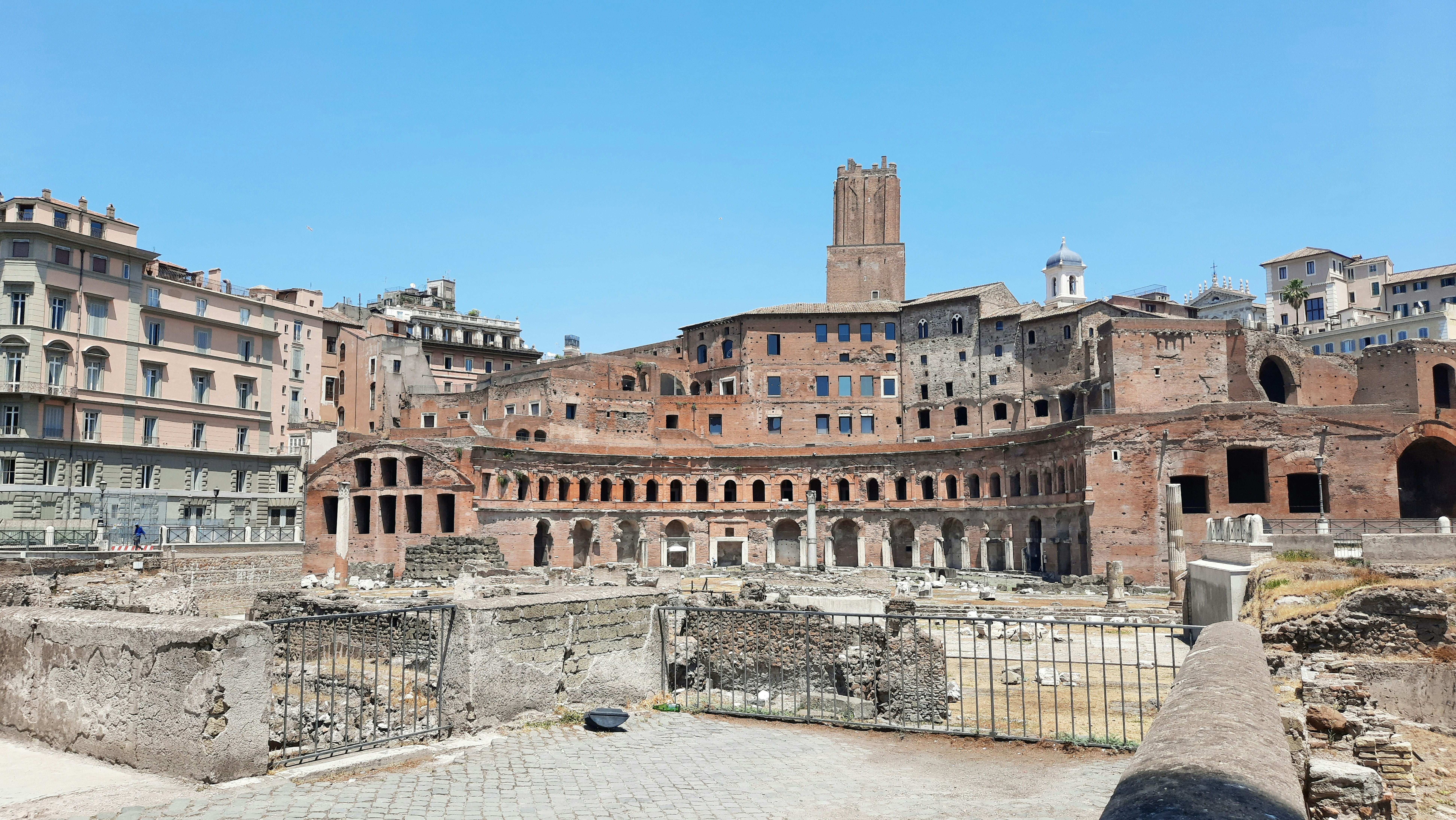 the ruins of a city with a clock tower in the background