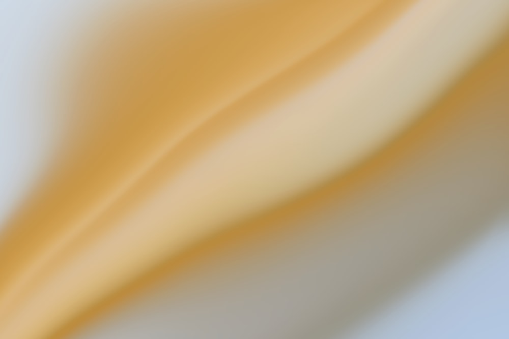 a blurry image of a yellow and white background