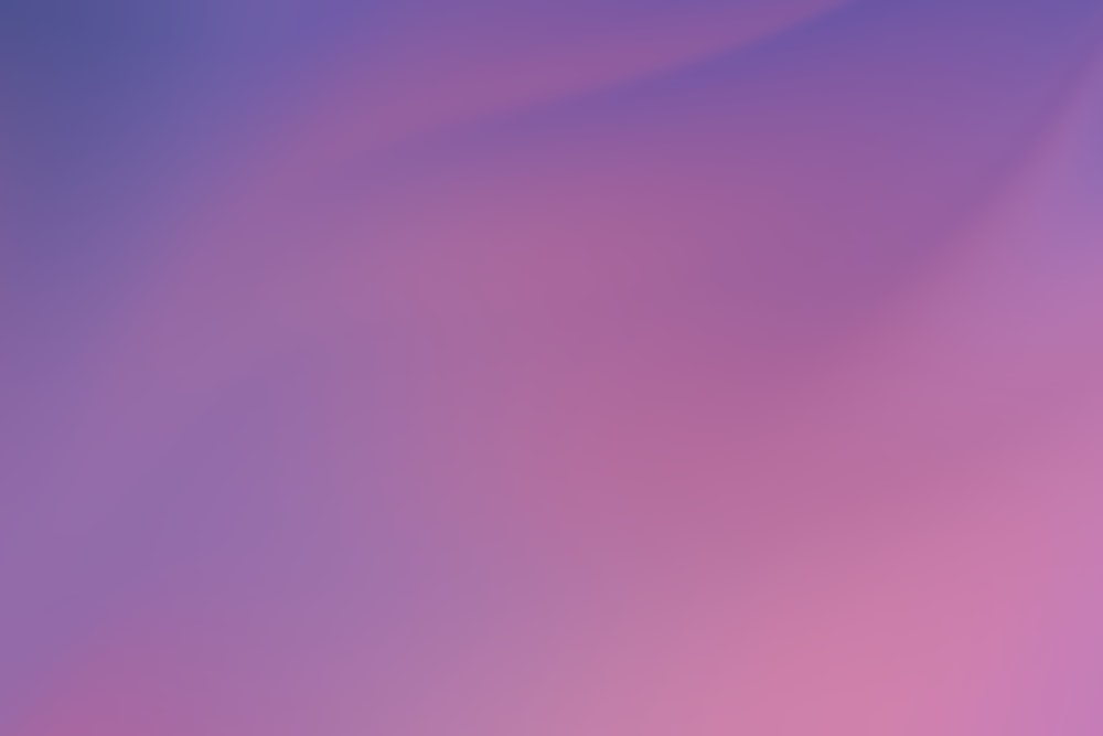 a blurry image of a purple and pink background