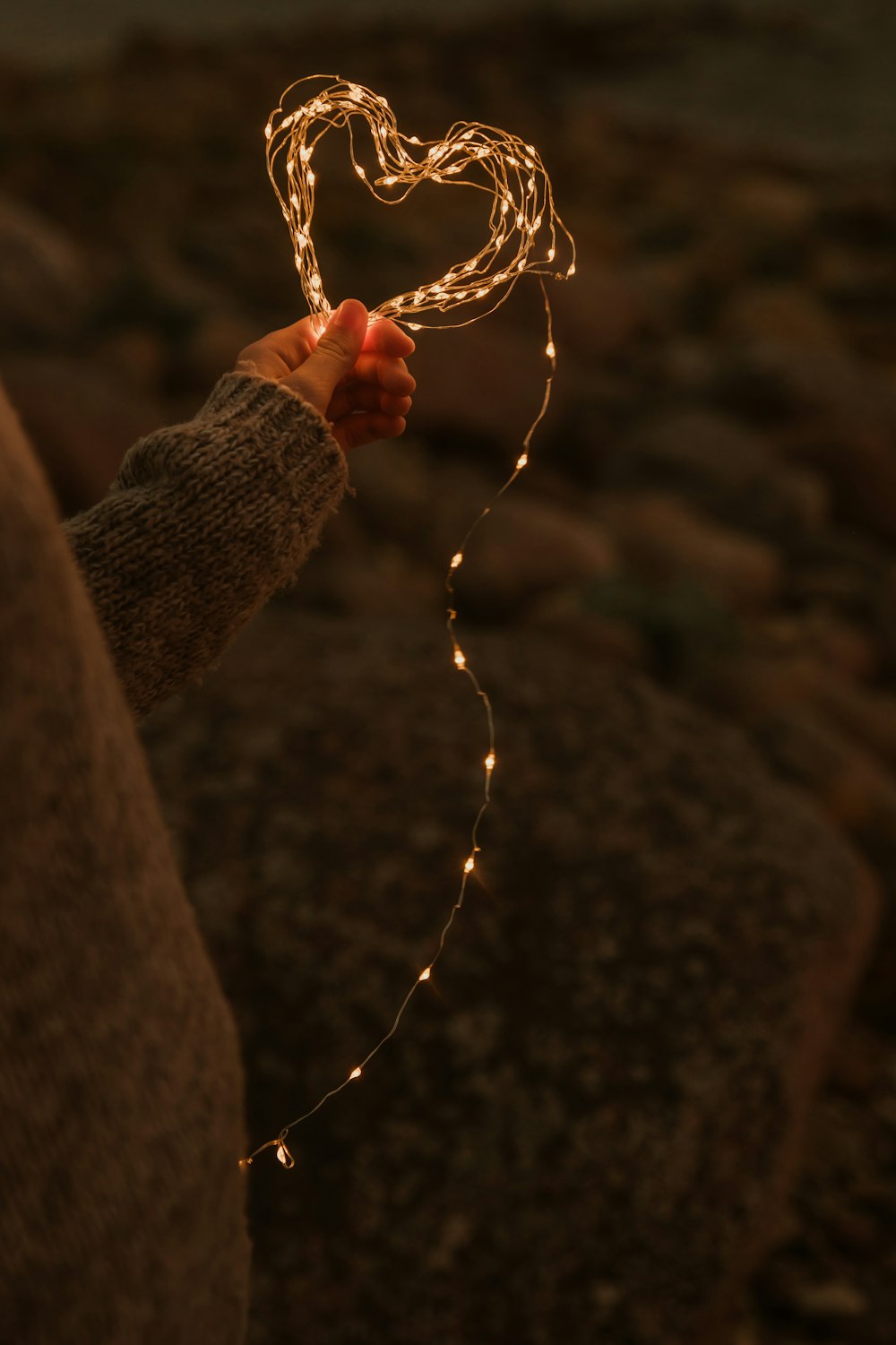 a person holding a string of lights in their hand