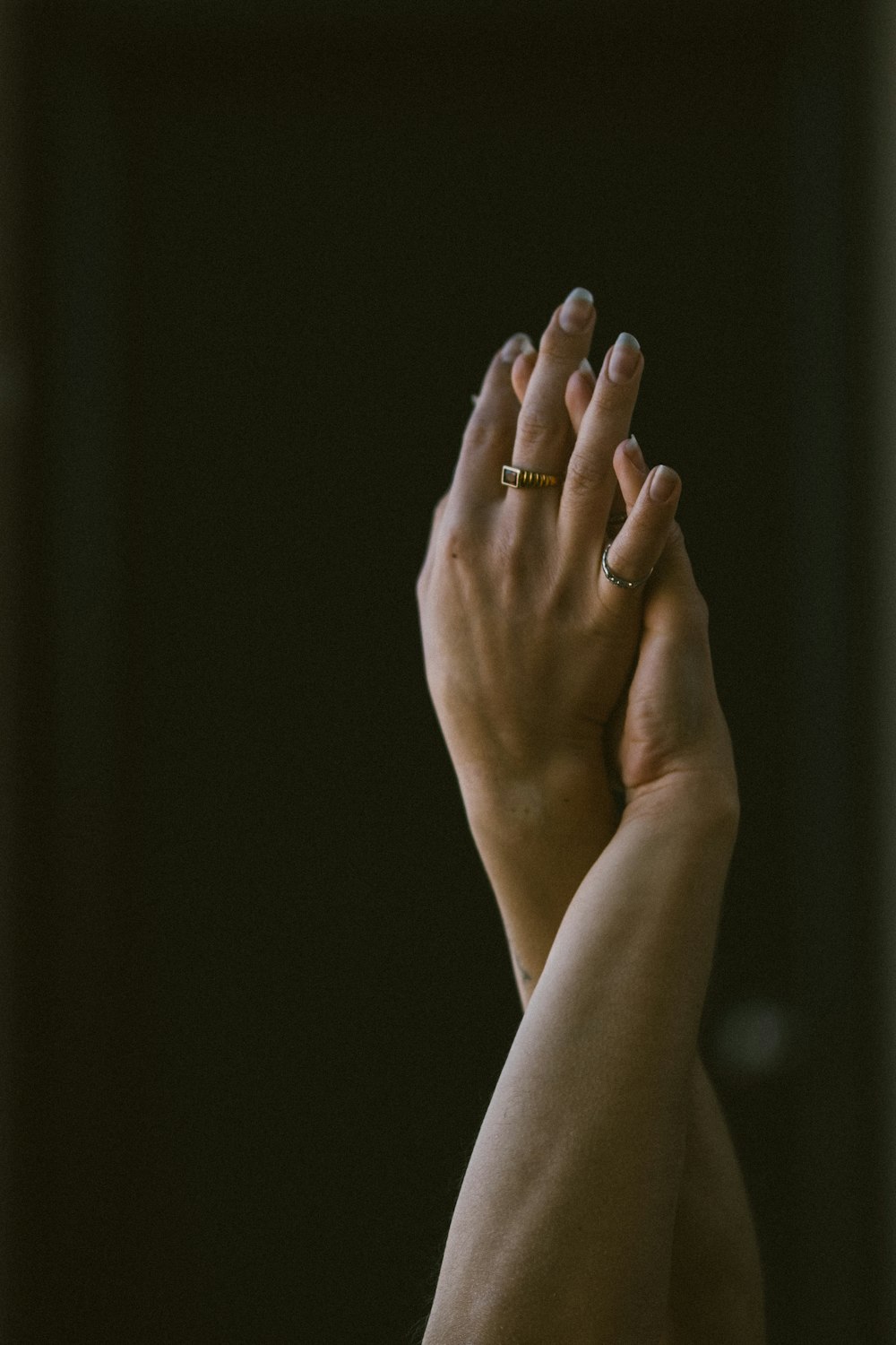 a woman holding her hands up in the air