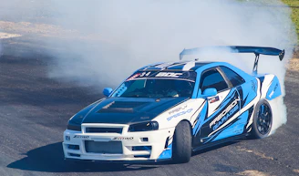 An RC drifter sliding smoothly around a sharp corner on a paved track.