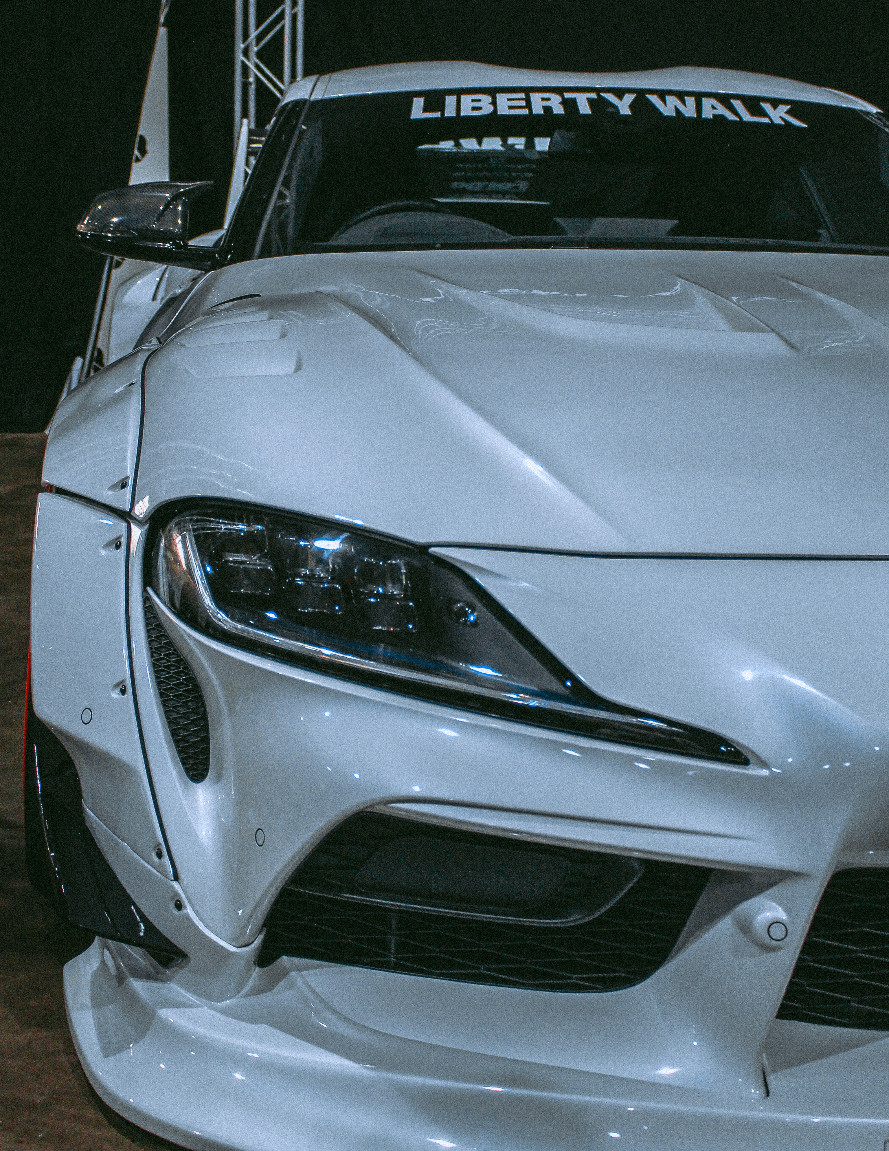 a white sports car with liberty walk on the hood