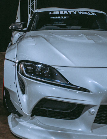 Side profile of a luxury car showcasing a custom body kit with sharp, aggressive lines.