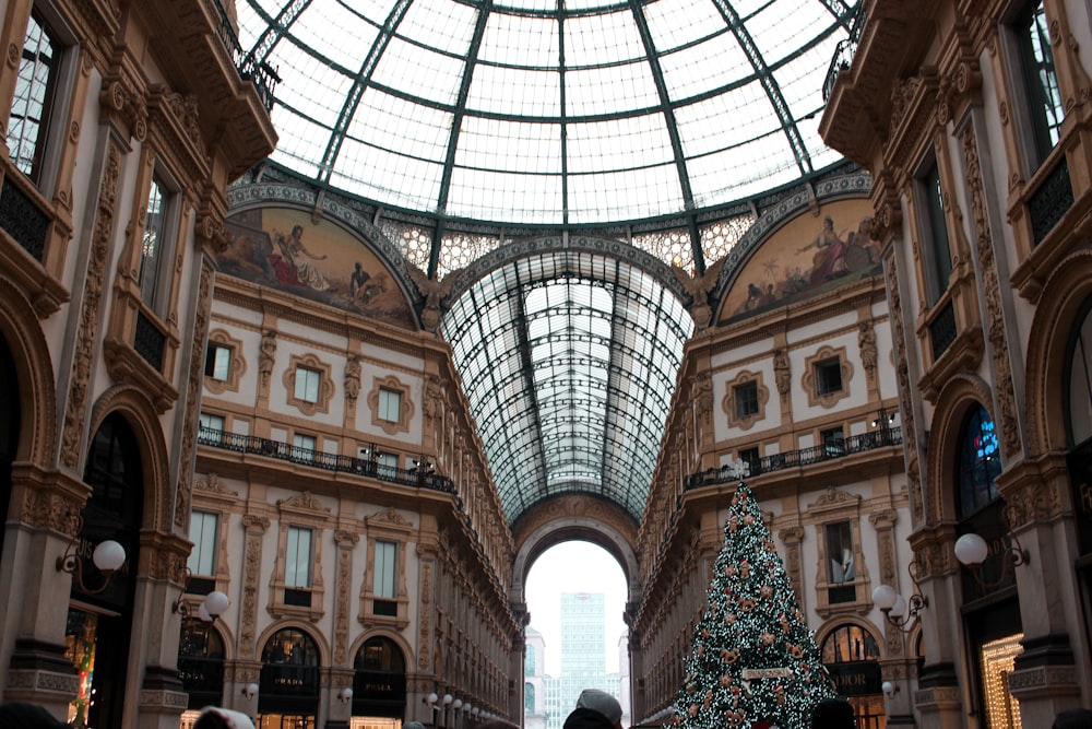 a christmas tree is in the middle of a shopping mall