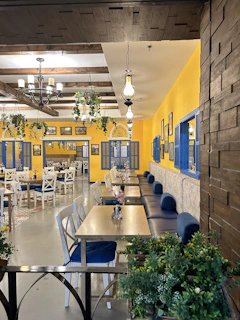 Warm Scandinavian-style restaurant interior with golden yellow and navy accents