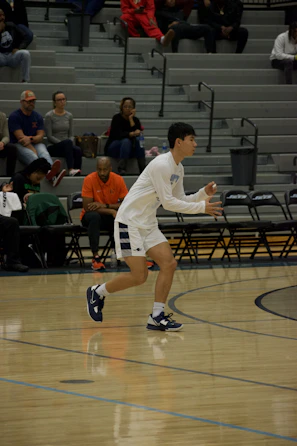 Young Michigan Dolphins athlete focused during a spirited basketball game.
